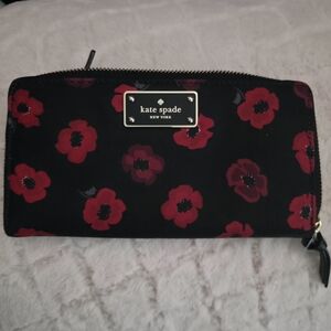 kate spade black wallet with red floral print and gold plaque